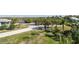 A landscaped street view with green lawns, palm trees and other foliage at 3476 Tidewater Dr, Weeki Wachee, FL 34607