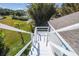 Rear exterior showcasing stairs to the rooftop viewing deck, and a lush yard of this coastal property at 3476 Tidewater Dr, Weeki Wachee, FL 34607