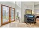 Elegant entryway with stained glass doors and piano at 363 Sanctuary Dr, Crystal Beach, FL 34681