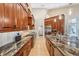 Gourmet kitchen boasts granite countertops, stainless steel appliances, and rich wood cabinetry at 363 Sanctuary Dr, Crystal Beach, FL 34681