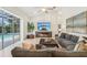 Bright living room with fireplace, large TV, and sliding glass doors to pool at 363 Sanctuary Dr, Crystal Beach, FL 34681