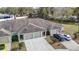 Aerial view of three-unit building with attached garages at 37804 Prairie Rose Loop, Zephyrhills, FL 33542