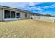 View of the home's exterior and a spacious backyard at 37804 Prairie Rose Loop, Zephyrhills, FL 33542