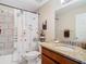 Bathroom with shower/tub combo, granite vanity, and tiled walls at 37804 Prairie Rose Loop, Zephyrhills, FL 33542