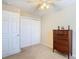 Bedroom with double door closet and ceiling fan at 37804 Prairie Rose Loop, Zephyrhills, FL 33542