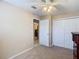 Bedroom with door to bathroom and double door closet at 37804 Prairie Rose Loop, Zephyrhills, FL 33542
