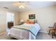 Bright bedroom with a double bed, ceiling fan, and en-suite bathroom access at 37804 Prairie Rose Loop, Zephyrhills, FL 33542