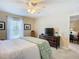 Bedroom with TV, ceiling fan and window coverings at 37804 Prairie Rose Loop, Zephyrhills, FL 33542