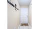 Interior entryway with tiled floor and coat hooks at 37804 Prairie Rose Loop, Zephyrhills, FL 33542