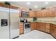 Modern kitchen with stainless steel appliances and granite countertops at 37804 Prairie Rose Loop, Zephyrhills, FL 33542