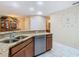 Kitchen with granite countertop, stainless steel dishwasher and view of bathroom at 37804 Prairie Rose Loop, Zephyrhills, FL 33542