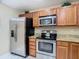 Modern kitchen with stainless steel appliances and granite countertops at 37804 Prairie Rose Loop, Zephyrhills, FL 33542