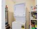 Laundry room with stackable washer and dryer, storage shelves at 37804 Prairie Rose Loop, Zephyrhills, FL 33542