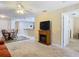 Living room featuring fireplace, comfortable seating and view into dining area at 37804 Prairie Rose Loop, Zephyrhills, FL 33542