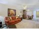 Open living room with electric fireplace and view of dining area at 37804 Prairie Rose Loop, Zephyrhills, FL 33542