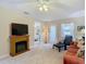 Relaxing living room with comfy couch and fireplace at 37804 Prairie Rose Loop, Zephyrhills, FL 33542