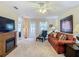 Spacious living room with comfortable seating and access to patio at 37804 Prairie Rose Loop, Zephyrhills, FL 33542