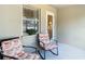Small patio with two rocking chairs and access to the interior at 37804 Prairie Rose Loop, Zephyrhills, FL 33542