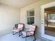 Relaxing patio with two rocking chairs, offering a peaceful outdoor space at 37804 Prairie Rose Loop, Zephyrhills, FL 33542