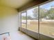 Spacious screened porch overlooking a backyard with mature trees at 37804 Prairie Rose Loop, Zephyrhills, FL 33542