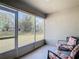 Relaxing screened porch with rocking chairs and backyard view at 37804 Prairie Rose Loop, Zephyrhills, FL 33542