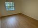 Light-filled bedroom with wood-look floors and large window at 4511 S Oak Dr # R12, Tampa, FL 33611