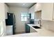 Modern kitchen with white cabinets, quartz countertops, and black appliances at 4511 S Oak Dr # R12, Tampa, FL 33611
