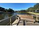 Serene lake view from a wooden pier bench at 4511 S Oak Dr # R12, Tampa, FL 33611