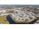 Aerial view of the condo complex featuring a community pool, tennis courts, and lush landscaping at 455 Alt 19 S # 268, Palm Harbor, FL 34683