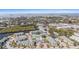 Aerial view of condo community with a pool and tennis courts close to waterways and beautiful foliage at 455 Alt 19 S # 268, Palm Harbor, FL 34683
