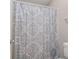 Bathroom featuring a patterned shower curtain and essential fixtures, providing a functional space at 455 Alt 19 S # 268, Palm Harbor, FL 34683