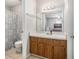 This bathroom features wooden cabinets, a large mirror, and a patterned shower curtain at 455 Alt 19 S # 268, Palm Harbor, FL 34683