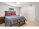 This bedroom features tile floors, a ceiling fan, and a dark wooden bed frame with a gray bedspread at 455 Alt 19 S # 268, Palm Harbor, FL 34683
