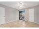 A spacious bedroom with neutral color palette, tile floors and access to private patio at 455 Alt 19 S # 268, Palm Harbor, FL 34683