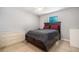 This bedroom features tile floors, a ceiling fan, and a dark wooden bed frame with a gray bedspread at 455 Alt 19 S # 268, Palm Harbor, FL 34683