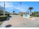 A charming brick paved entrance to Harbor Club lined with lush landscaping and palm trees at 455 Alt 19 S # 268, Palm Harbor, FL 34683