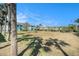 View of community lawn with picnic tables and tropical foliage creating a relaxing outdoor space at 455 Alt 19 S # 268, Palm Harbor, FL 34683