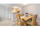 A well-lit dining area with a wooden table and six chairs, conveniently located near the kitchen at 455 Alt 19 S # 268, Palm Harbor, FL 34683