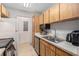 Charming kitchen features wood cabinets, stainless steel appliances, and a double sink for convenience at 455 Alt 19 S # 268, Palm Harbor, FL 34683