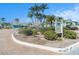 Lush landscaping with tropical plants and flowers surrounds the community clubhouse at 455 Alt 19 S # 268, Palm Harbor, FL 34683