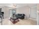 Bright living room featuring tile floors, a ceiling fan and sliding glass door to the patio at 455 Alt 19 S # 268, Palm Harbor, FL 34683