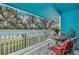 This patio has blue ceilings and railings, a glass table, and outdoor seating at 455 Alt 19 S # 268, Palm Harbor, FL 34683
