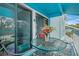 This patio has blue ceilings and railings, a glass table, and outdoor seating at 455 Alt 19 S # 268, Palm Harbor, FL 34683