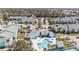 Aerial view of a community pool surrounded by lounge chairs and palm trees in a residential neighborhood at 455 Alt 19 S # 268, Palm Harbor, FL 34683