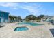 Community pool area with tables and chairs for lounging and shaded areas for relaxation at 455 Alt 19 S # 268, Palm Harbor, FL 34683
