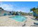 Community pool surrounded by lounge chairs and umbrellas, perfect for relaxation at 455 Alt 19 S # 268, Palm Harbor, FL 34683