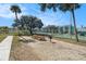 Outdoor recreation area with picnic tables, barbeque, and fenced tennis courts at 455 Alt 19 S # 268, Palm Harbor, FL 34683