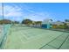 Community tennis court with an enclosed fence ensuring privacy and safety at 455 Alt 19 S # 268, Palm Harbor, FL 34683