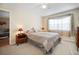 Cozy bedroom with neutral decor and a large window at 460 Paula S Dr # 401, Dunedin, FL 34698