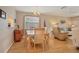 Bright dining area with wood table and chairs, hardwood floors, and access to living room at 460 Paula S Dr # 401, Dunedin, FL 34698